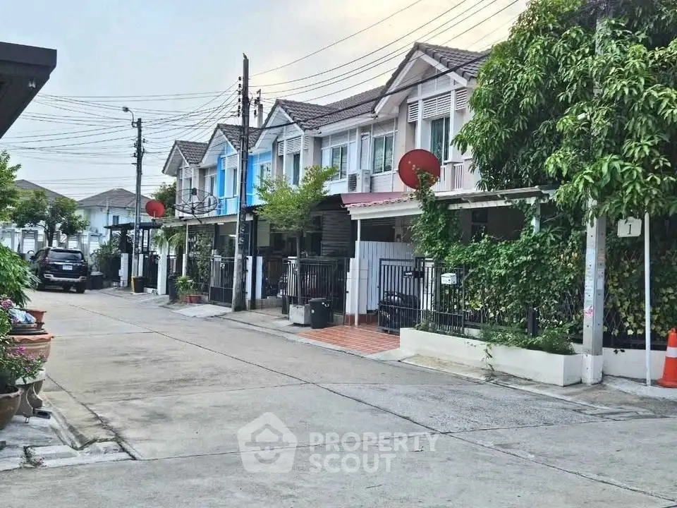 Charming townhouse row with lush greenery and modern design in a serene neighborhood.