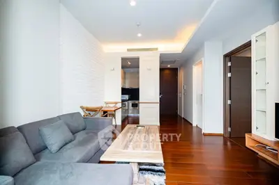 Modern living room with stylish furniture and open kitchen layout in a contemporary apartment.