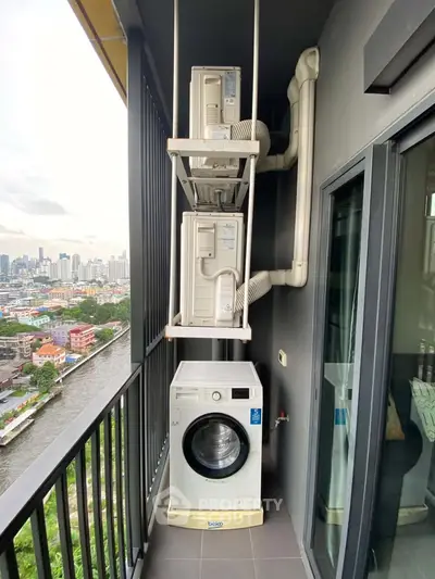 High-rise balcony with washing machine and city view, perfect for urban living.