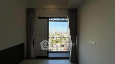 Spacious bedroom with balcony offering stunning city view