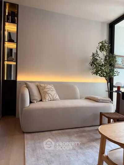 Modern living room with stylish sofa and ambient lighting, perfect for relaxation and comfort.