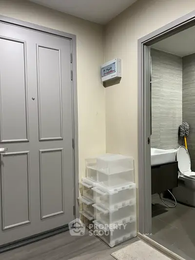 Modern apartment entrance with bathroom view and storage drawers