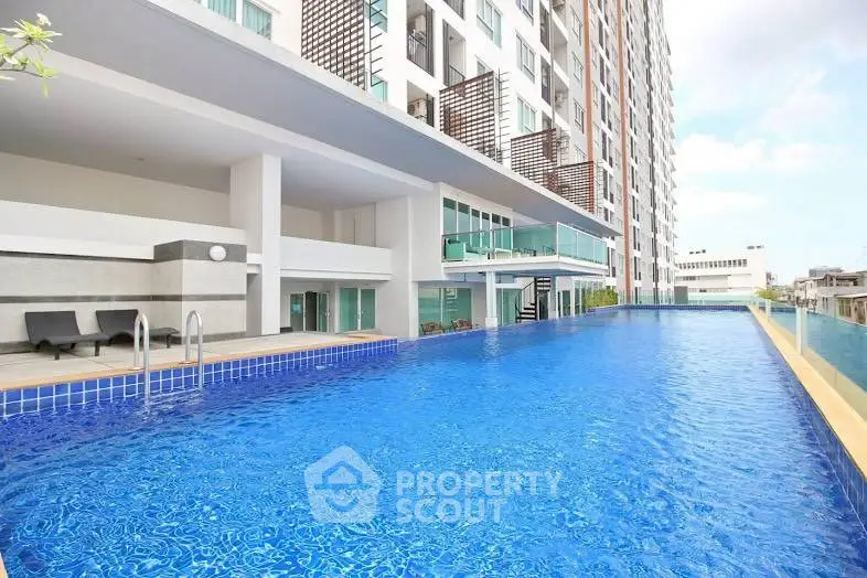 Luxurious high-rise building with stunning rooftop pool and modern amenities.