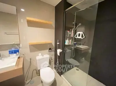Modern bathroom with glass shower and sleek fixtures