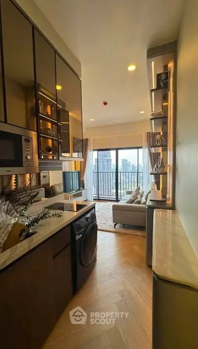 Modern apartment with open kitchen and living room, featuring city view from balcony.