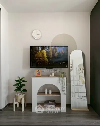 Stylish modern living room corner with TV, mirror, and decor accents.