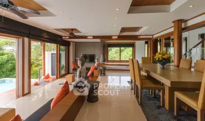 Luxurious open-plan living room with pool view and elegant dining area, featuring modern decor and ample natural light.