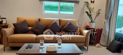 Cozy living room with stylish sofa and modern decor, perfect for relaxation.