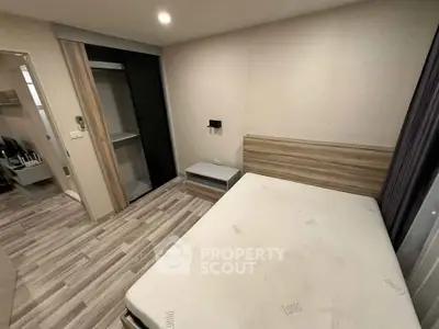 Modern bedroom with minimalist design and built-in wardrobe in a stylish apartment.
