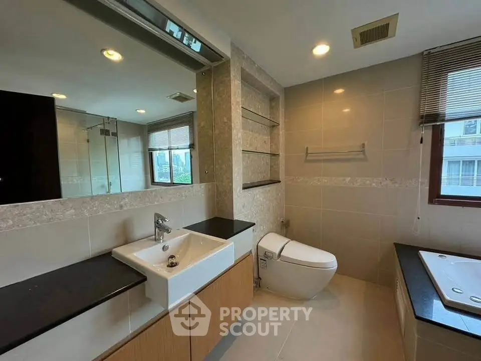 Modern bathroom with sleek fixtures and large mirror