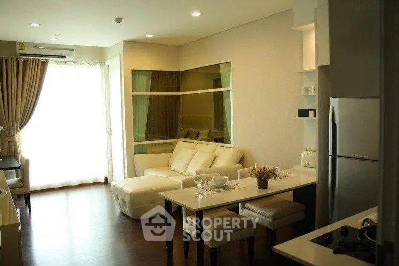 Modern living room with open kitchen layout and stylish decor