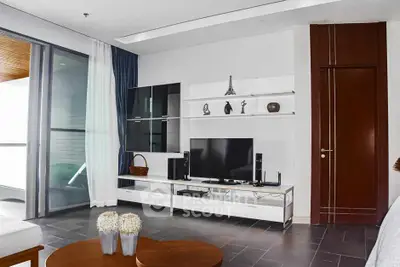Modern living room with sleek TV unit and balcony view