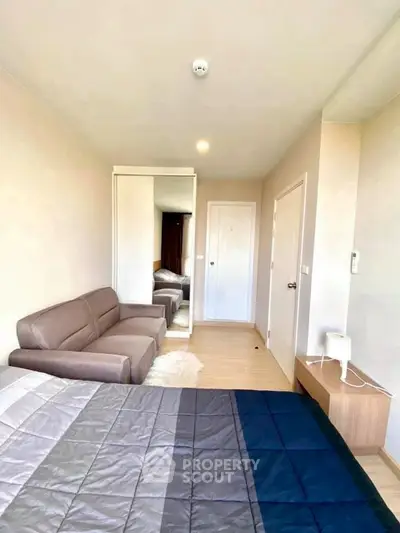 Modern bedroom with cozy sofa and stylish decor in a bright apartment