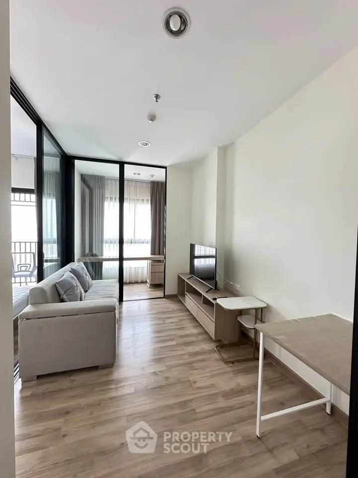Modern living room with sleek furniture and large windows in a stylish apartment.