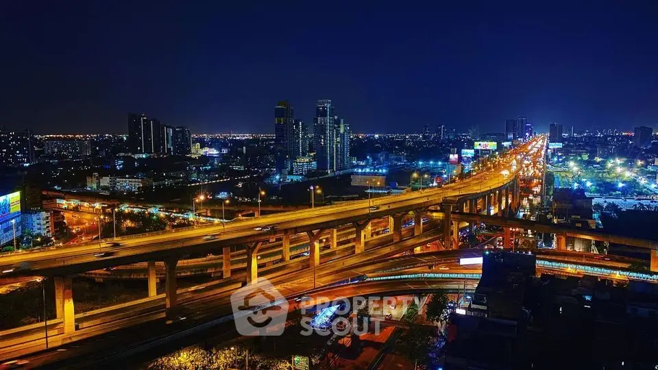 Stunning night view of city skyline with illuminated highways and skyscrapers, perfect for urban living.