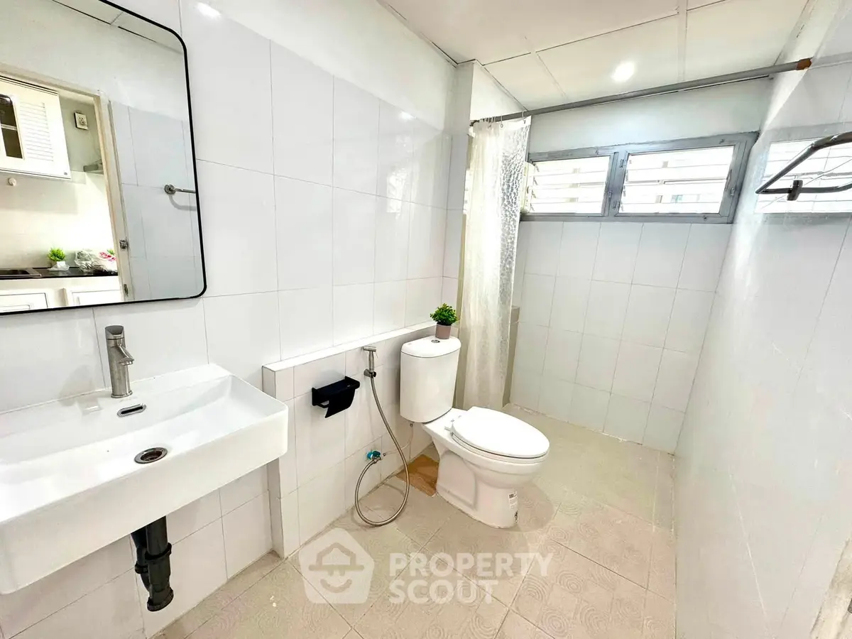 Spacious modern bathroom with sleek fixtures and natural light