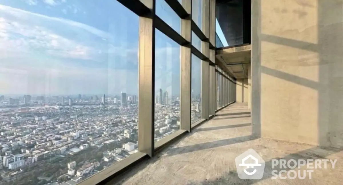 Stunning high-rise building view with panoramic cityscape from floor-to-ceiling windows.