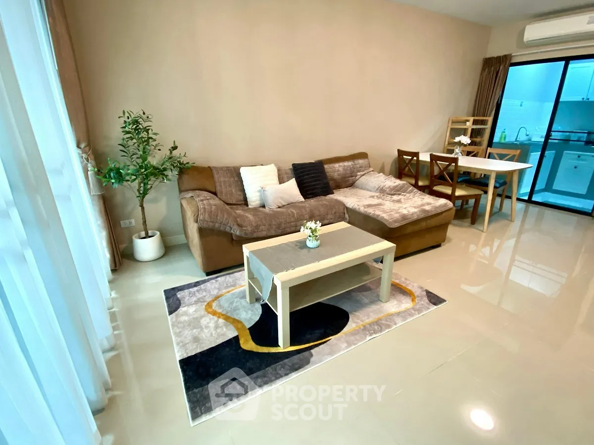 Spacious living room with modern decor and open kitchen layout