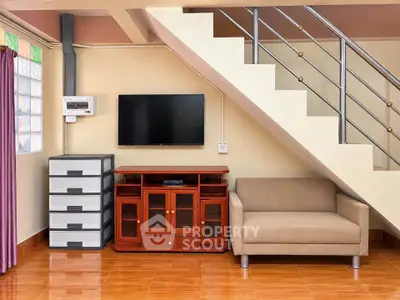 Modern living room with stylish staircase and cozy seating area