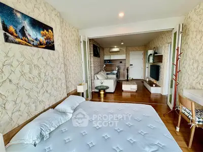 Spacious bedroom with modern decor and open layout to living area