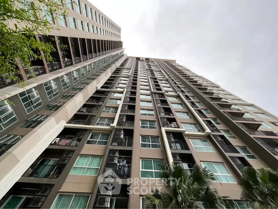 Stunning high-rise building exterior with modern architecture and lush greenery, perfect for urban living.