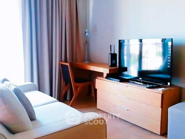 Modern living room with sleek TV setup and cozy seating area.