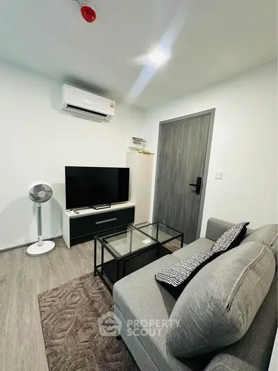 Modern living room with sleek furniture and air conditioning in a cozy apartment.