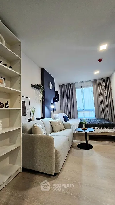 Modern living room with cozy sofa and stylish decor in a bright apartment.