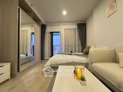 Modern bedroom with stylish decor and large mirrored wardrobe in a cozy apartment.