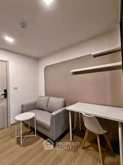 Modern living room with cozy sofa and stylish desk in a compact apartment