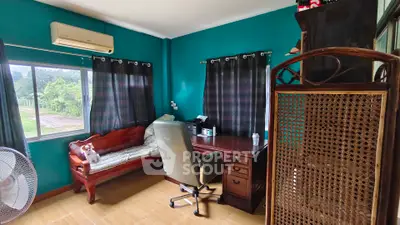 Charming home office with wooden furniture and garden view, perfect for productivity.
