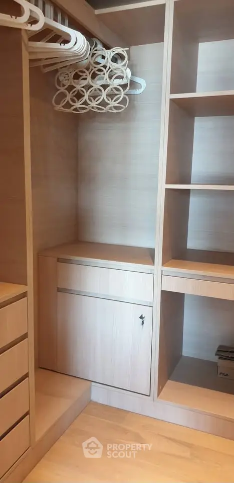 Spacious walk-in closet with wooden shelves and ample storage space.