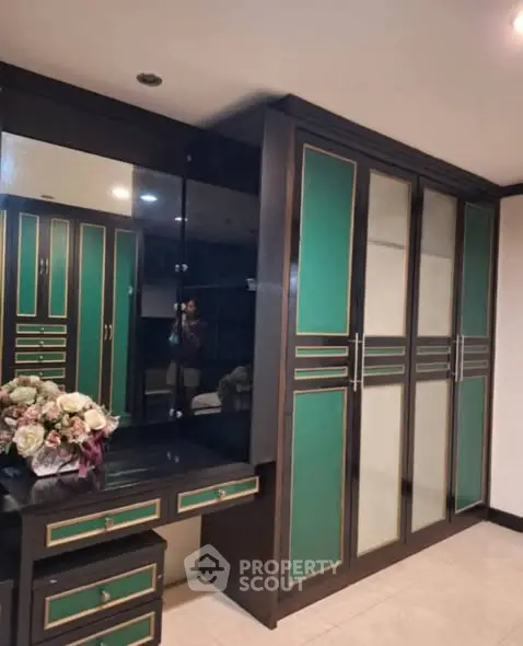 Spacious bedroom with elegant built-in wardrobe and vanity area