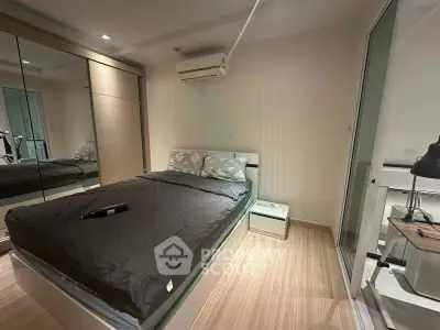 Modern bedroom with mirrored closet and sleek design in a stylish apartment.