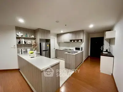 Modern kitchen with sleek cabinetry and stainless steel appliances in a stylish apartment.