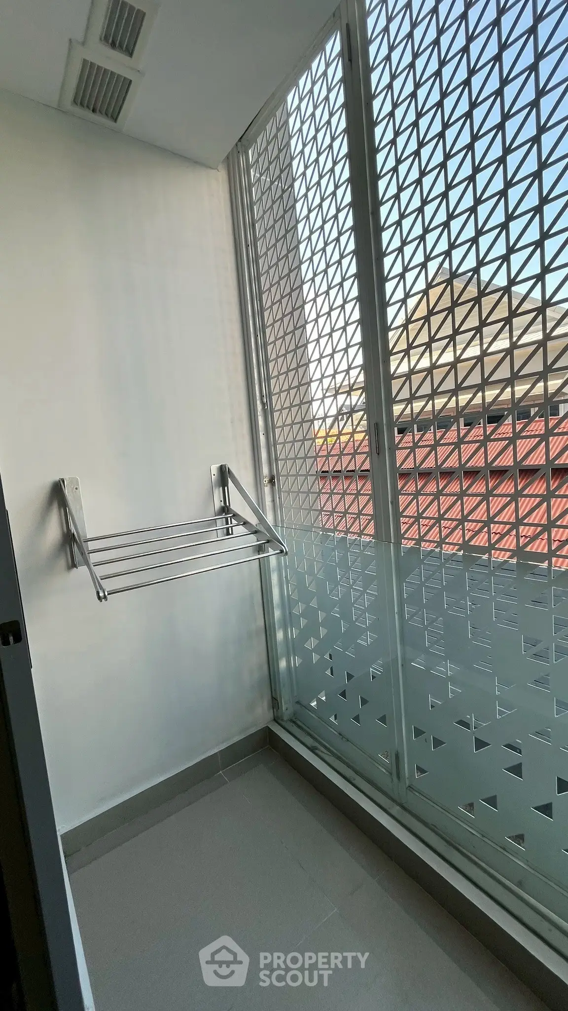 Modern balcony with metal railing and city view, perfect for urban living.