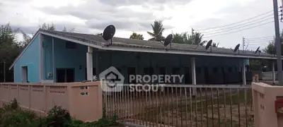 Charming blue single-story building with multiple satellite dishes, ideal for rental units.