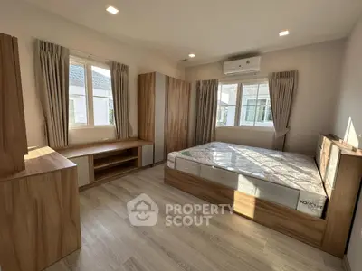 Spacious bedroom with modern wooden furniture and natural light