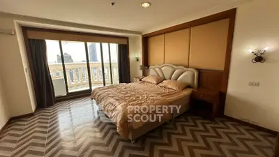 Luxurious bedroom with elegant decor and balcony view in high-rise apartment