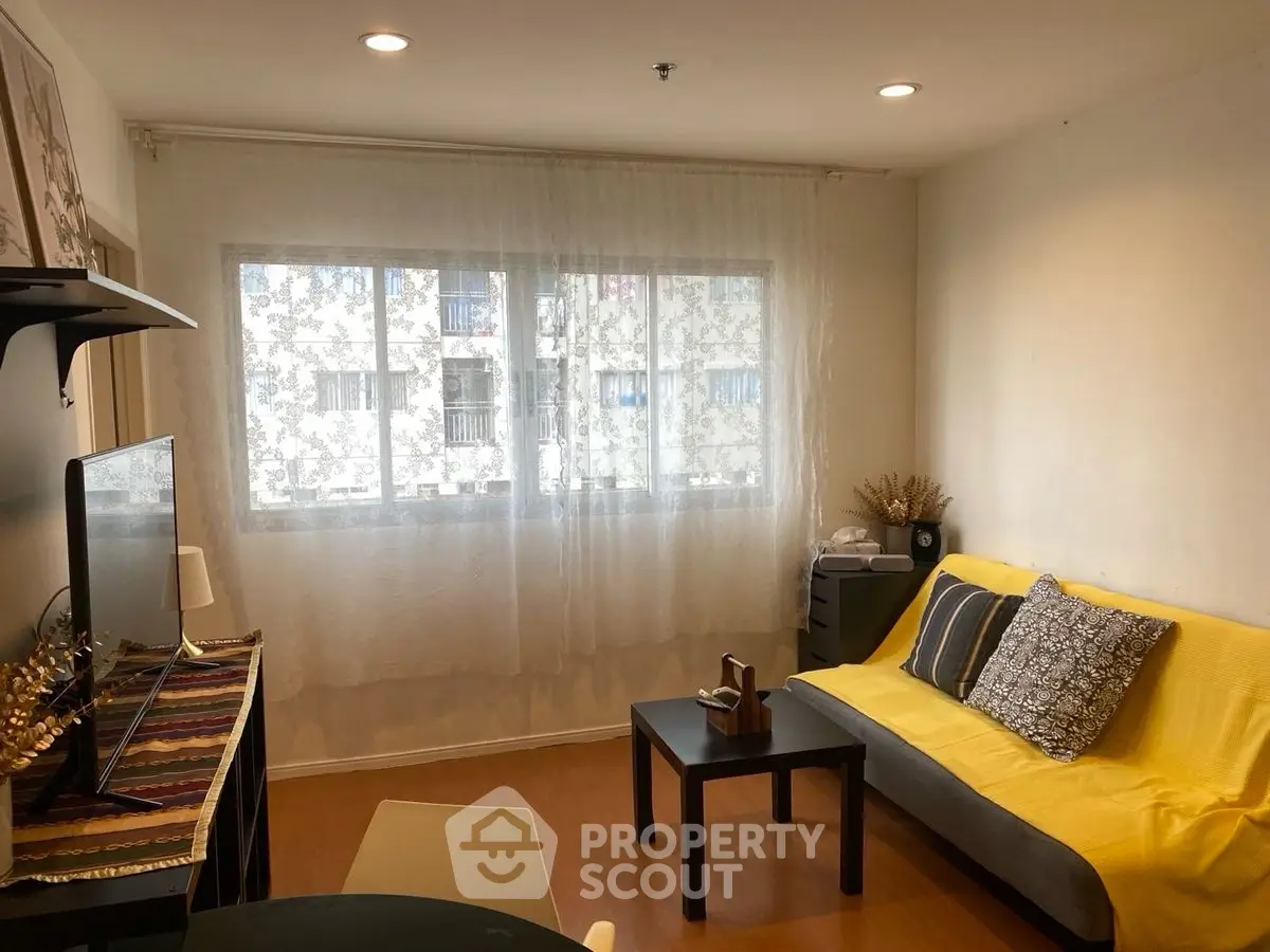 Cozy living room with yellow sofa and modern decor, perfect for relaxation.