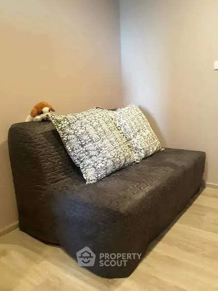 Cozy small living room with a stylish sofa and decorative pillows.