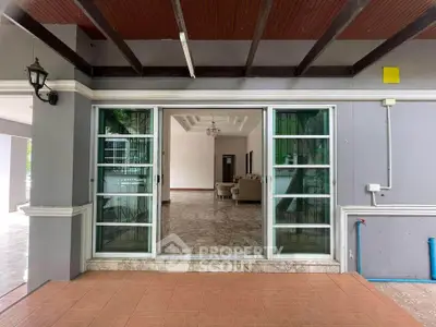 Spacious living room with elegant marble flooring and large glass doors