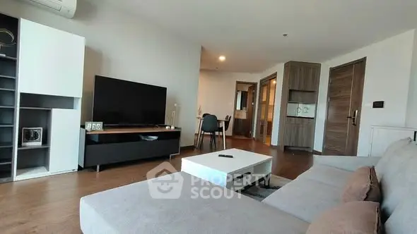 Spacious modern living room with sleek furniture and open layout, perfect for relaxation and entertainment.