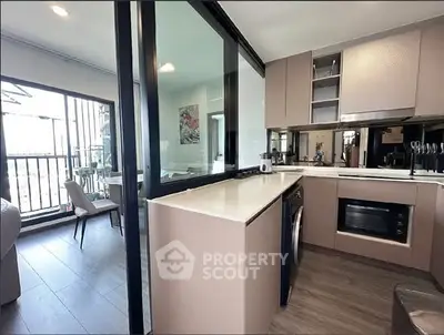 Modern kitchen with sleek cabinetry and open layout in stylish apartment.