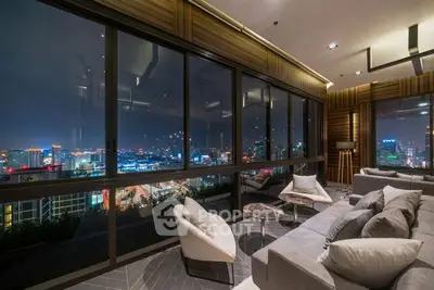 Luxurious living room with panoramic city view and modern furnishings.
