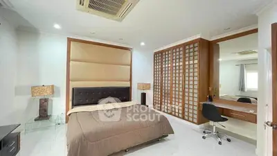 Spacious bedroom with modern decor and built-in wardrobe, perfect for comfort and style.