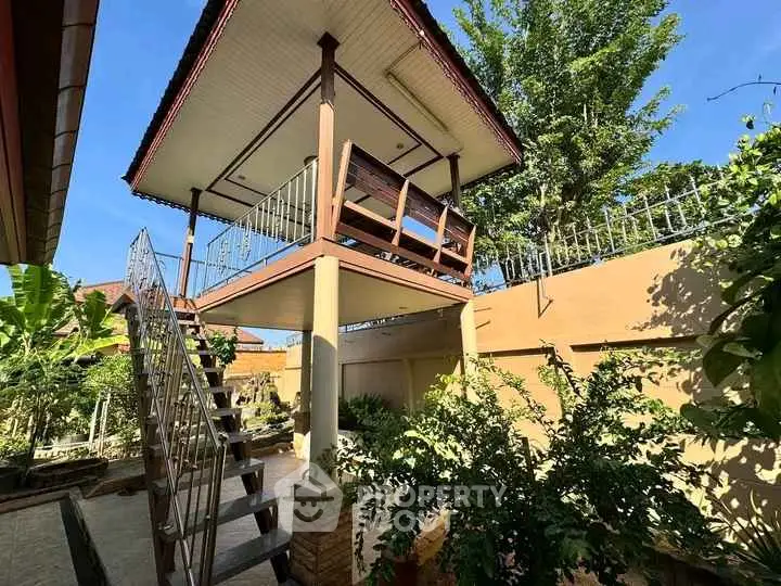 Charming elevated outdoor gazebo in lush garden setting, perfect for relaxation and enjoying nature.