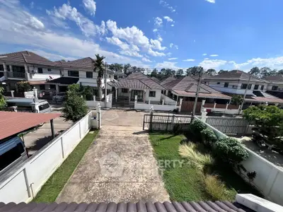 Charming suburban neighborhood with spacious driveways and modern homes under a clear blue sky.