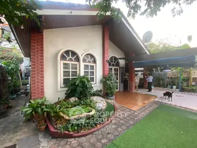 Charming single-story home with lush garden and spacious patio, perfect for outdoor living.