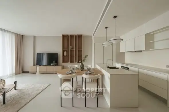 Modern open-plan living room and kitchen with sleek design and neutral tones.